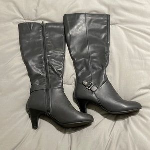 Gray heeled high boots.